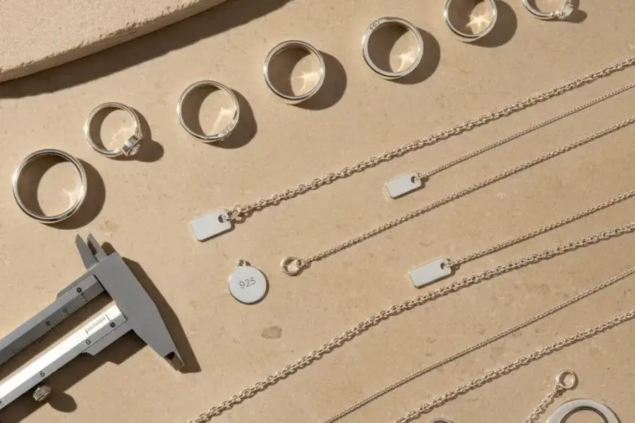 Is 925 sterling silver real guide hero image showing authentic sterling silver jewelry with visible 925 hallmarks and quality inspection tools